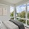 a room with a bed and a window with a view of the city